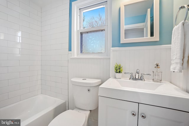 full bathroom featuring vanity, toilet, and tiled shower / bath