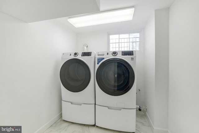 washroom featuring washer and clothes dryer