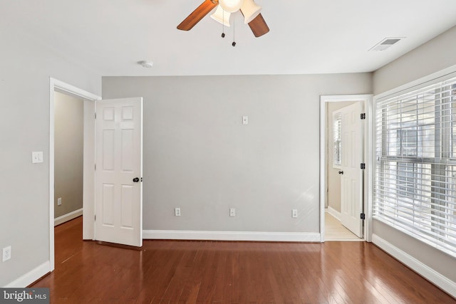 empty room featuring hardwood / wood-style floors, a wealth of natural light, and ceiling fan