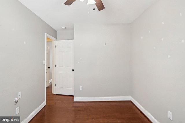 empty room with dark wood-type flooring and ceiling fan