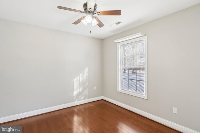 spare room with wood-type flooring and ceiling fan