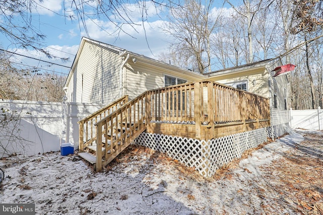 view of snow covered exterior featuring a wooden deck