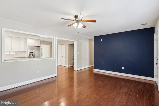 unfurnished living room featuring dark hardwood / wood-style flooring and ceiling fan