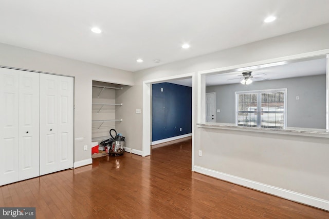 interior space featuring ceiling fan and dark hardwood / wood-style flooring