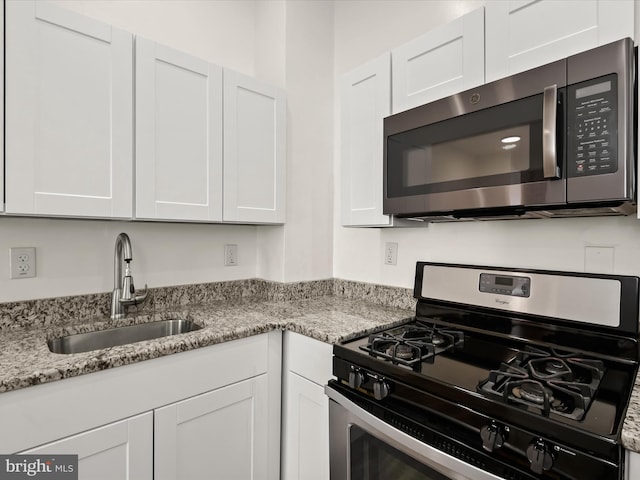 kitchen featuring white cabinetry, sink, and stainless steel appliances