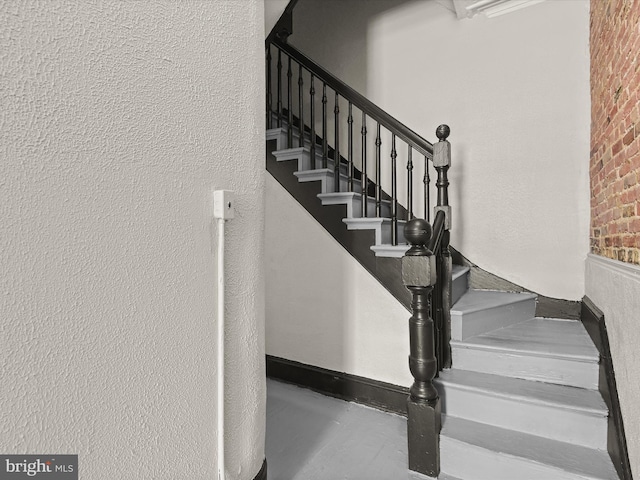 stairs featuring concrete floors