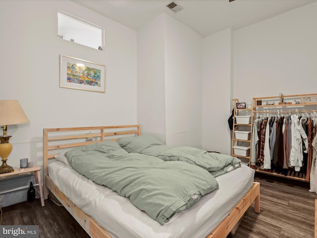 bedroom with dark hardwood / wood-style flooring