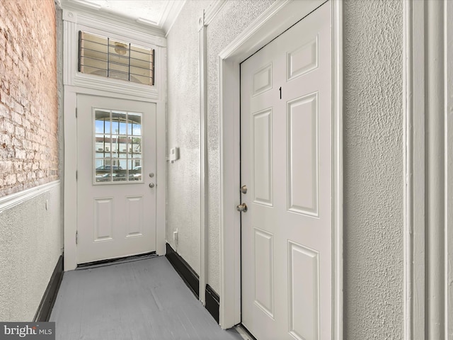 doorway featuring ornamental molding