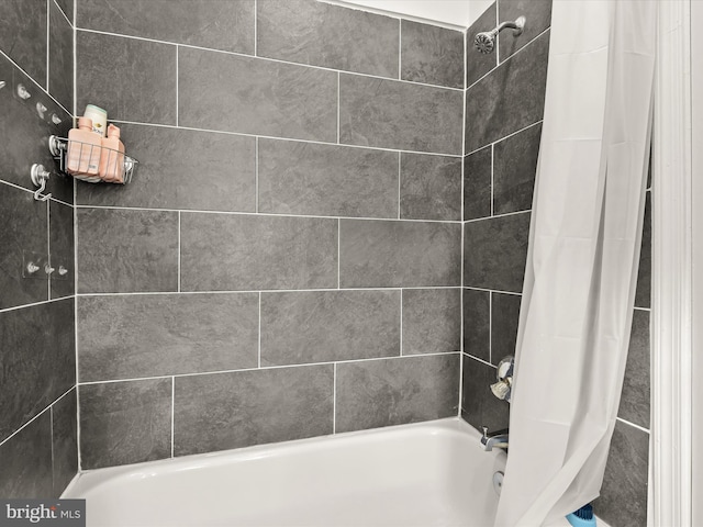 bathroom with shower / bath combo with shower curtain