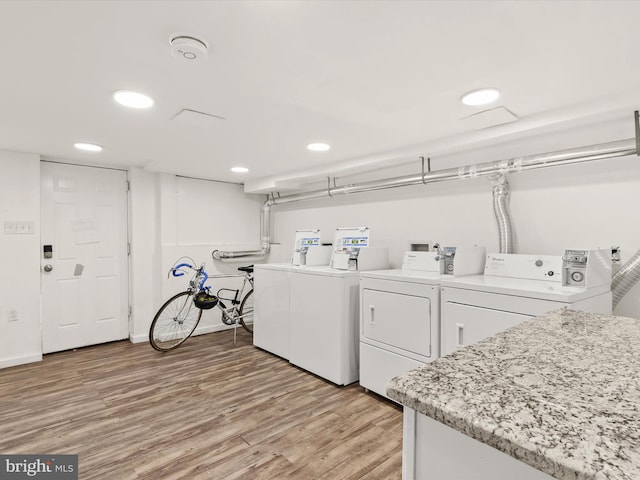 washroom with washer and dryer and light wood-type flooring