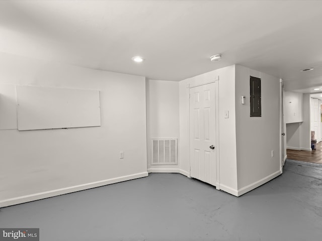 unfurnished room with concrete flooring and electric panel