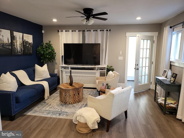 living room with ceiling fan, french doors, and wood-type flooring