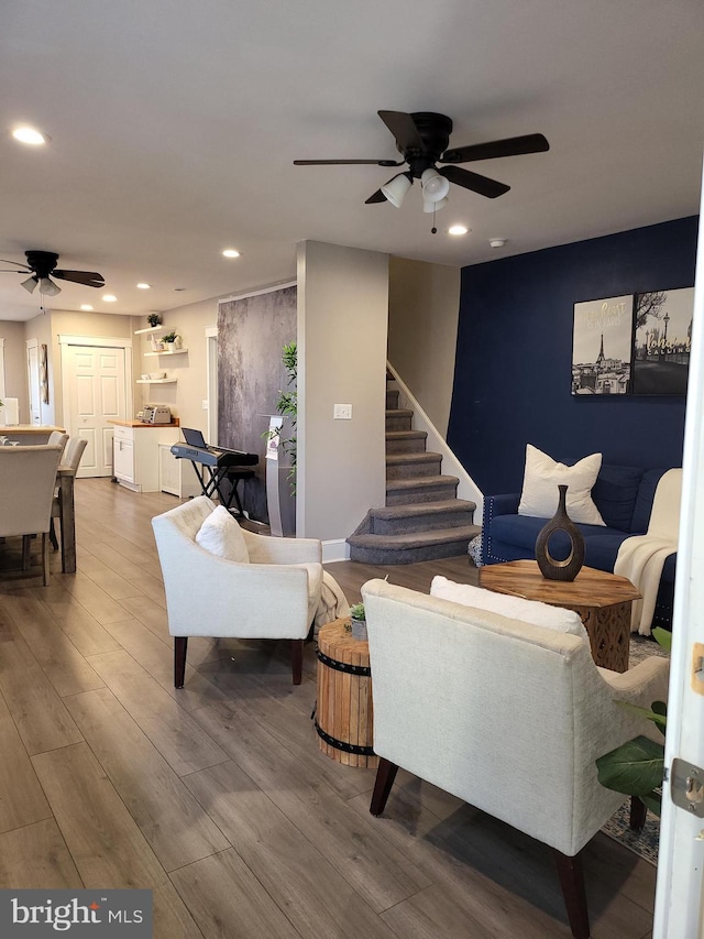 living room with wood-type flooring and ceiling fan