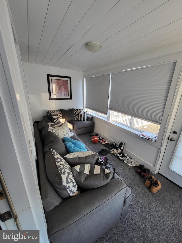 carpeted living room featuring wooden ceiling