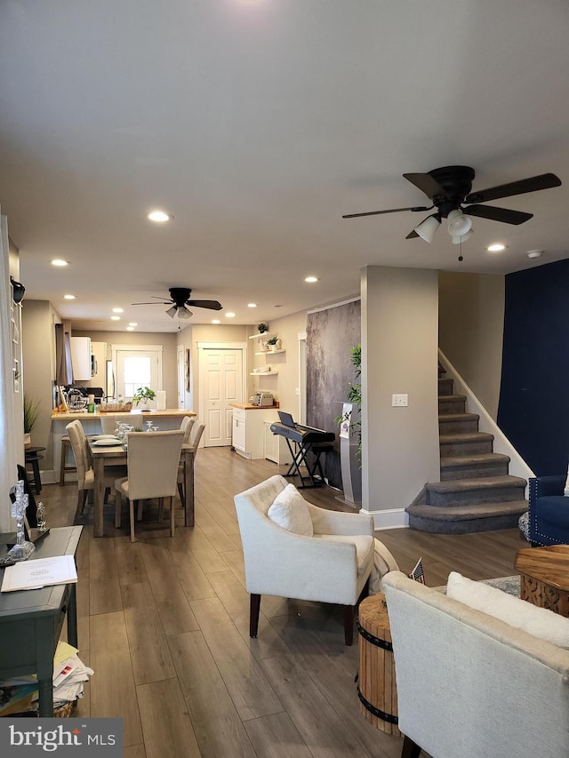 living room with ceiling fan and wood-type flooring