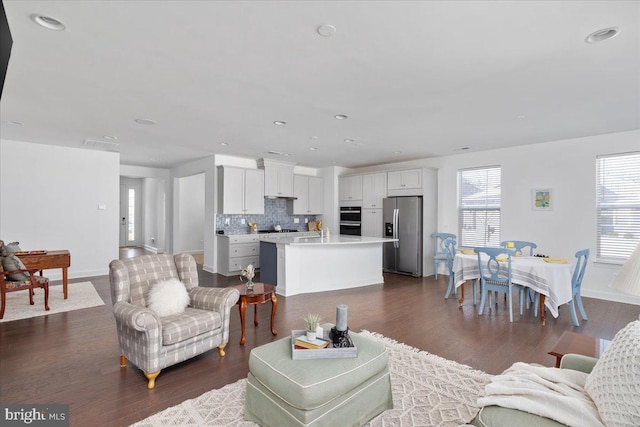 living room with dark hardwood / wood-style flooring and sink