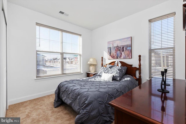 bedroom with light colored carpet