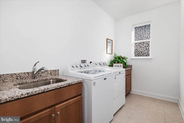 laundry room with sink, cabinets, and washing machine and clothes dryer