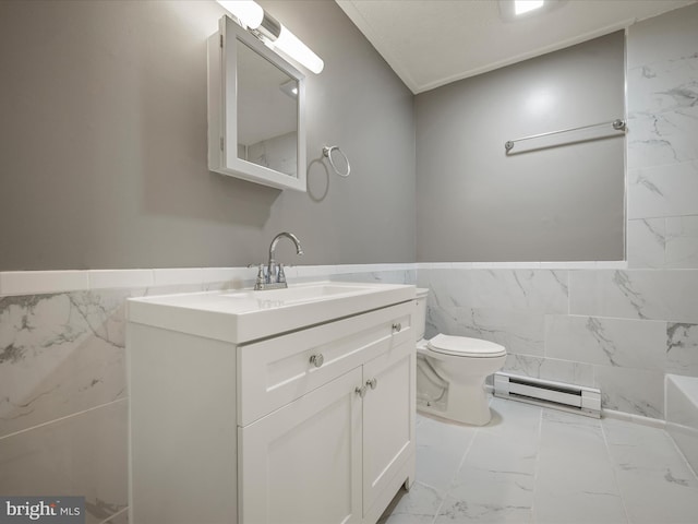 bathroom featuring toilet, vanity, tile walls, and baseboard heating