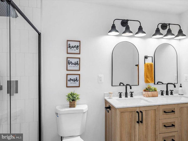 bathroom featuring vanity, toilet, and walk in shower