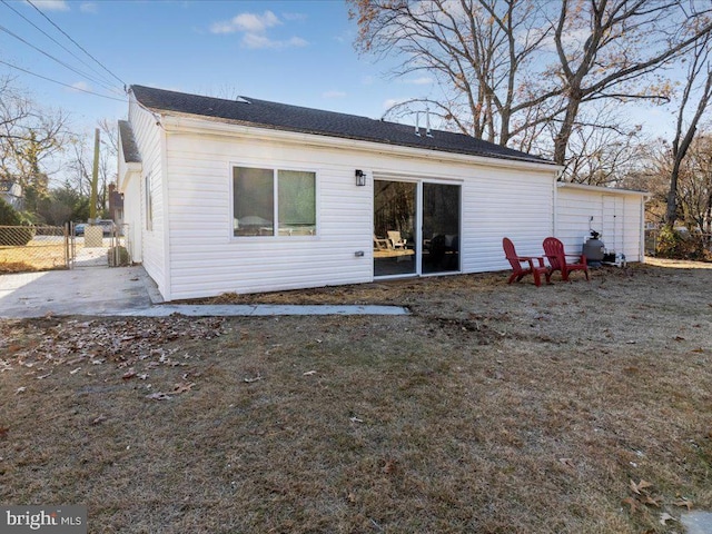 rear view of house featuring a yard