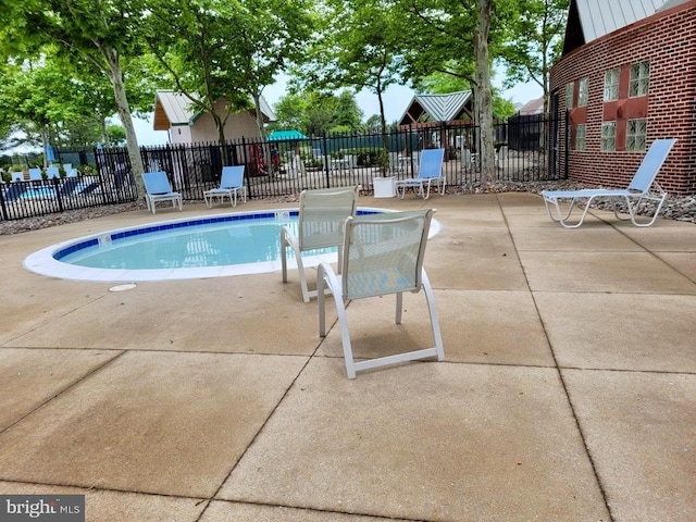 view of swimming pool featuring a patio