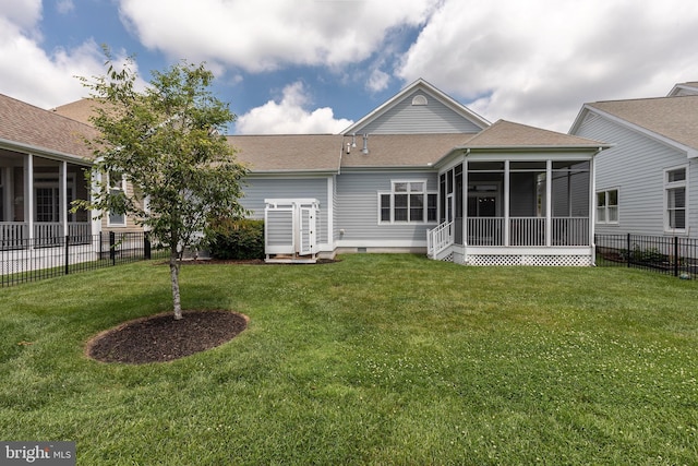 back of property featuring a lawn and a sunroom