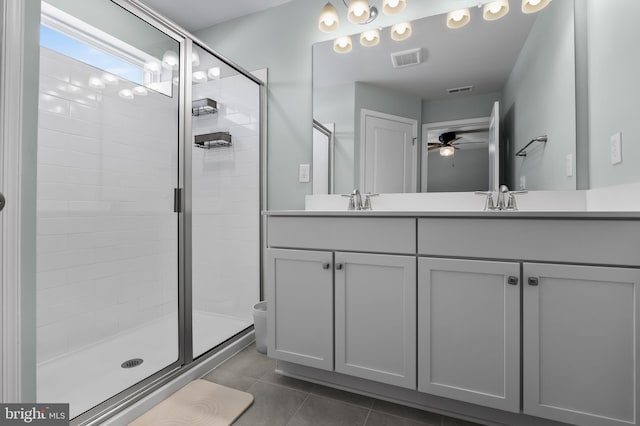 bathroom featuring ceiling fan, vanity, an enclosed shower, and tile patterned flooring