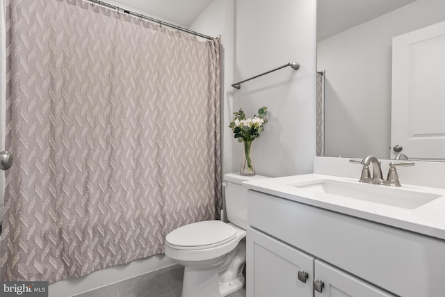 bathroom featuring tile patterned flooring, vanity, and toilet