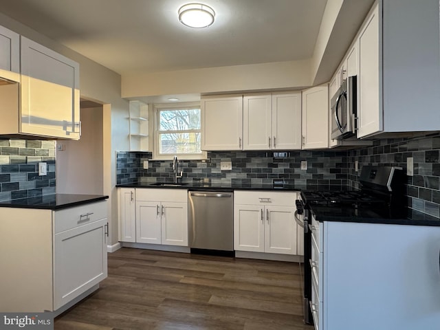 kitchen with sink, white cabinetry, tasteful backsplash, dark hardwood / wood-style floors, and stainless steel appliances