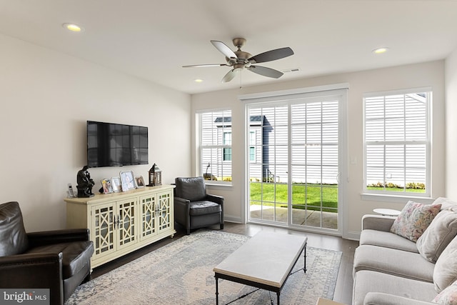 living room featuring hardwood / wood-style floors and ceiling fan