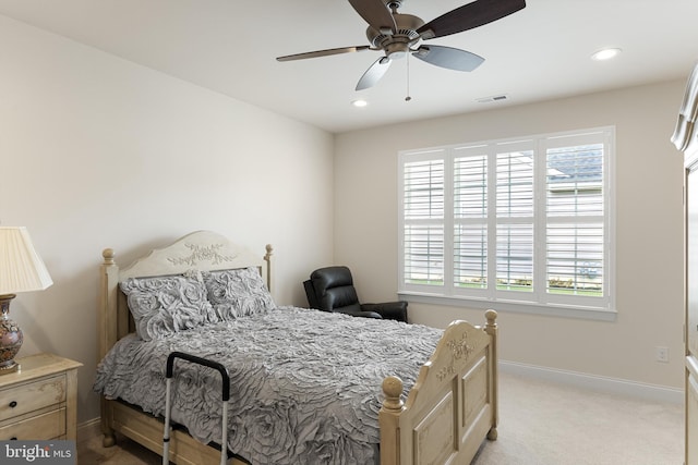 bedroom featuring light colored carpet and ceiling fan