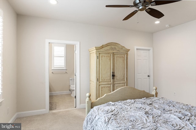 carpeted bedroom featuring ensuite bath and ceiling fan