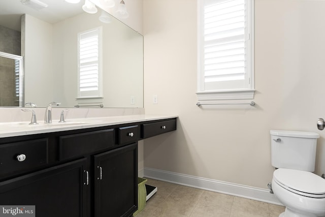 bathroom featuring tile patterned floors, vanity, and toilet