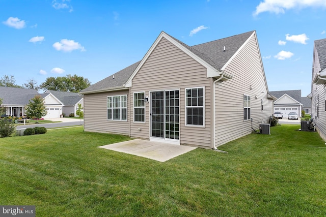 rear view of house with a lawn, central air condition unit, and a patio