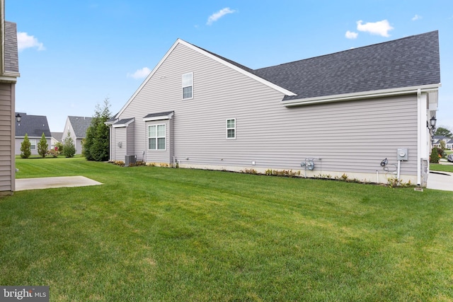 rear view of property featuring a yard