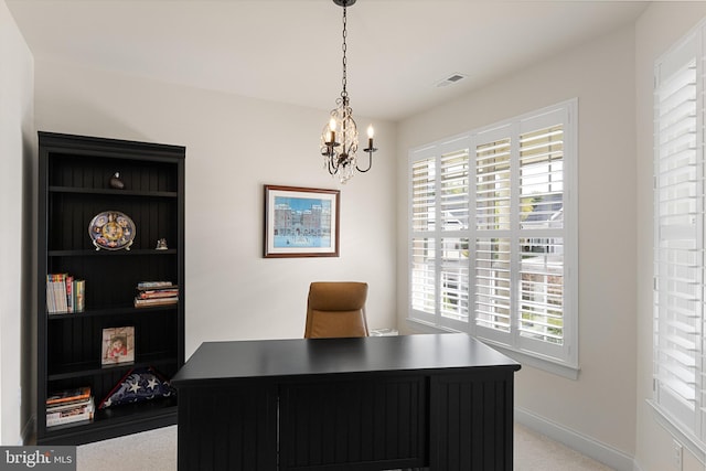 office area with light carpet and a notable chandelier