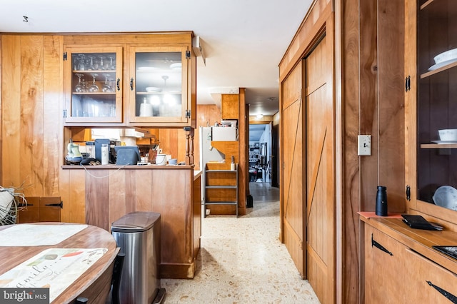 kitchen featuring wood walls