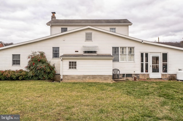 back of property featuring a yard