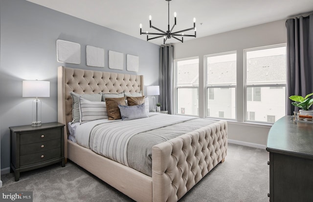 bedroom with light carpet and a chandelier