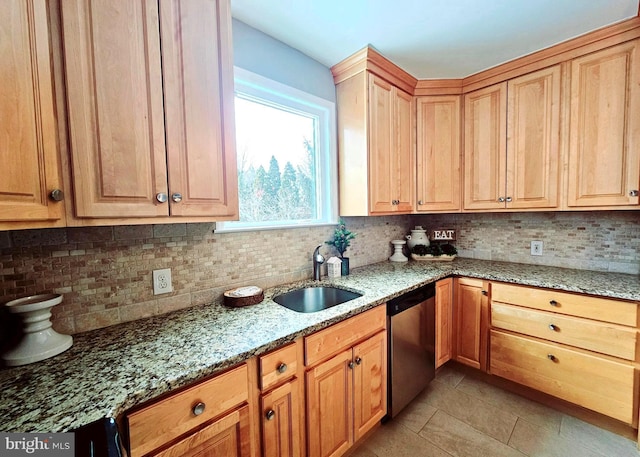 kitchen featuring light tile patterned floors, decorative backsplash, light stone countertops, stainless steel dishwasher, and sink