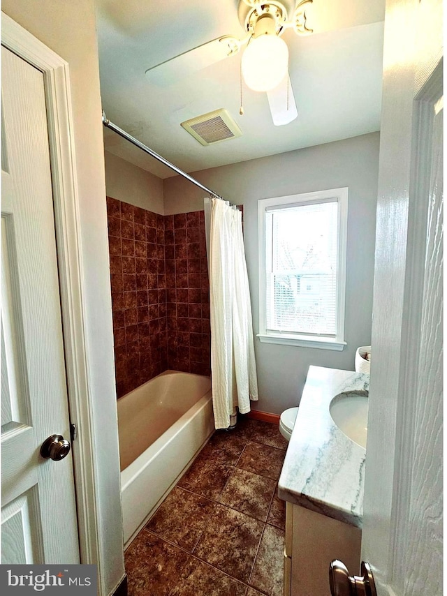 full bathroom with toilet, ceiling fan, vanity, and shower / bath combo with shower curtain