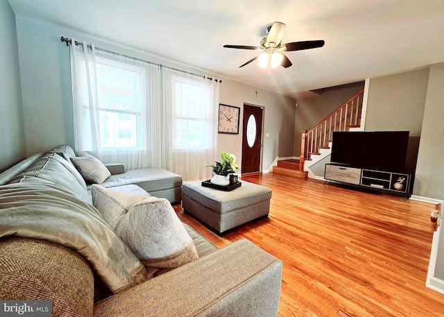 living room featuring ceiling fan and hardwood / wood-style floors