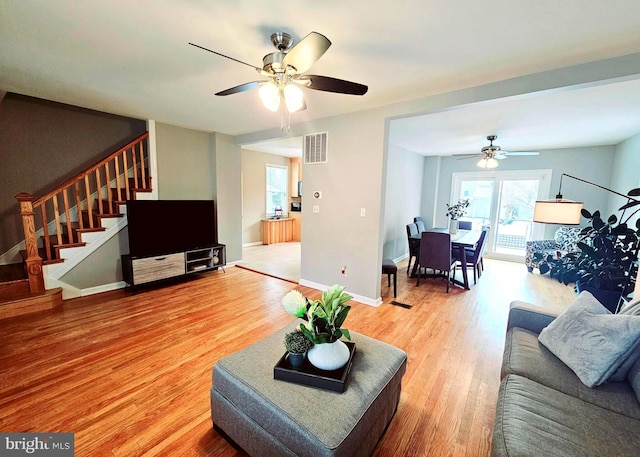 living room with hardwood / wood-style flooring and ceiling fan