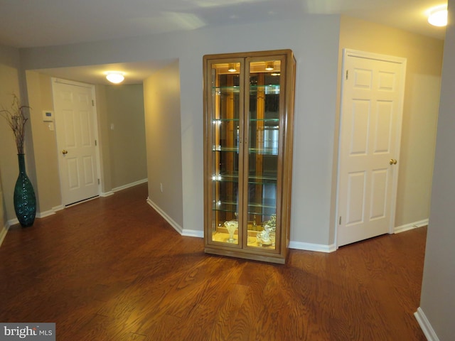 hallway with dark wood-type flooring