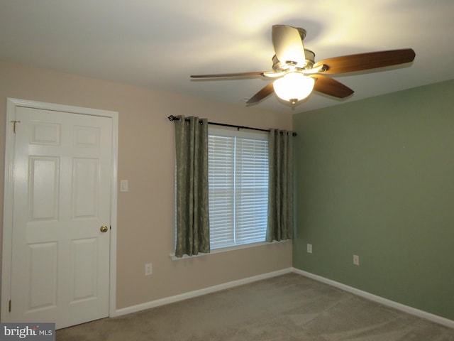 carpeted empty room featuring ceiling fan