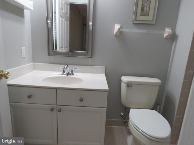 bathroom with tile patterned floors, vanity, and toilet