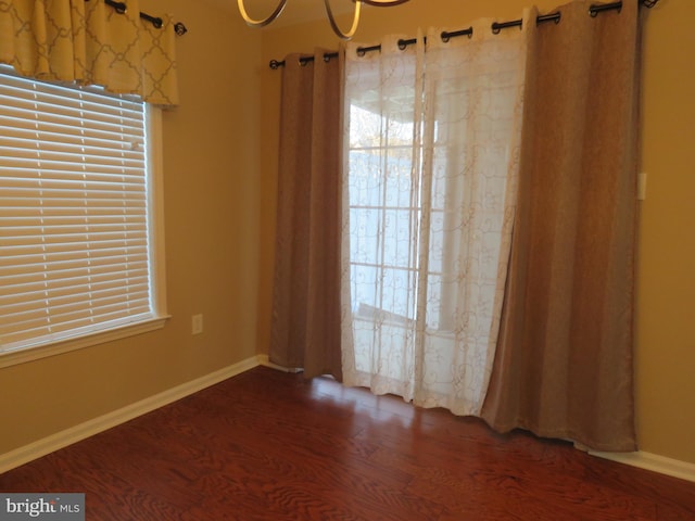 spare room featuring dark wood-type flooring