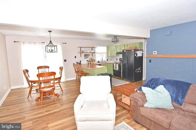 living room with sink and light hardwood / wood-style floors