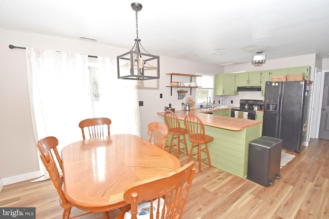 dining room with sink and light hardwood / wood-style flooring